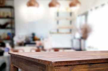 Selected focus empty brown wooden table and Coffee shop blur background with bokeh image. for your photomontage or product display