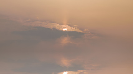 Sunset sky with sun reflected in water.