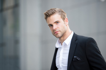 Businessman on the go. Guy handsome attractive office worker go meeting. Man well groomed elegant formal suit walks urban background. Businessman serious quick walk during lunch time