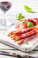 Bread sticks grissini with prosciutto