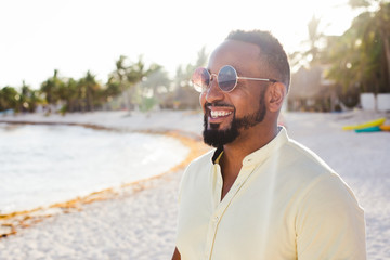 Ethnic man posing on beach