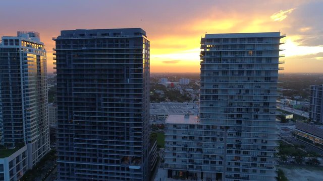Aerial drone reveal video sunset behind buildings motion 4k