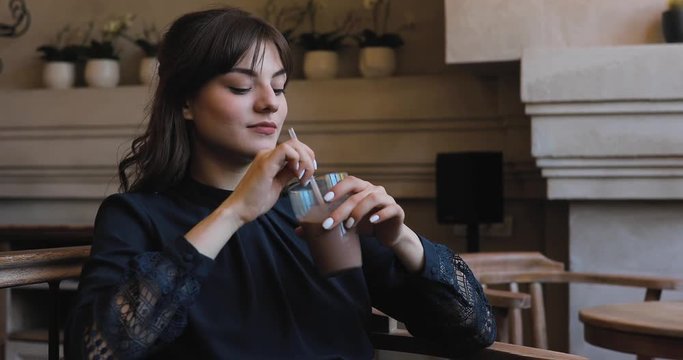 Girl in a cafe drinking frappe with ice