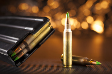 M855 ammo and magazine with bright holiday lights behind - obrazy, fototapety, plakaty