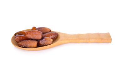 whole ripe date fruit in wooden spoon and on white background