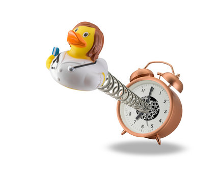 Female doctor rubber duck springing out of alarm clock isolated on white background