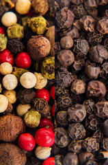 View from the top of dried red, black and white peppercorns