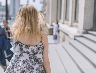 Outdoors portrait of young woman. View from back.