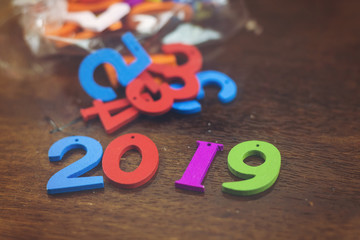 colorful wooden numbers forming the number 2019 and in plastic bag, For the new year 2019