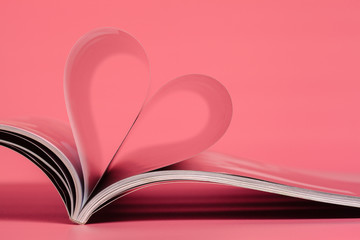 magazines on a pink background.