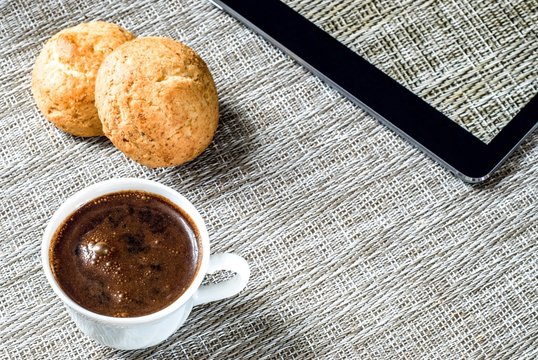 Morning coffee with bisquits and a tablet