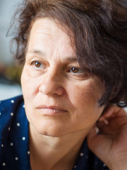 Portrait of a middle-aged woman with a sad expression for faces . Manifestation of emotions - sorrow, melancholia,  dreams_