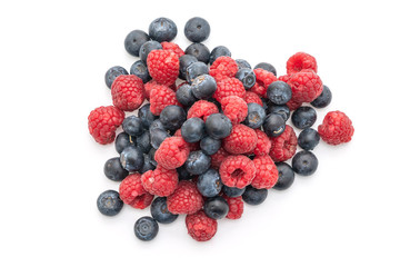 fresh raspberries and fresh blueberries on white background