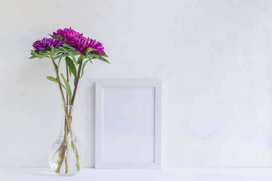 Mockup with a white frame and pink flower in a vase