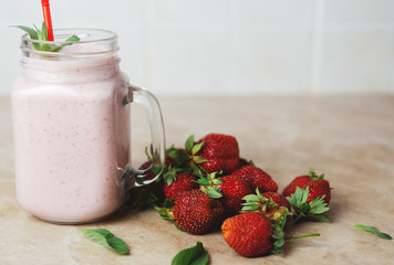 Strawberry milkshake with the scattered ripe berries