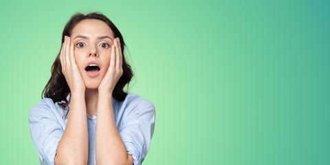 Portrait of young woman with shocked facial expression