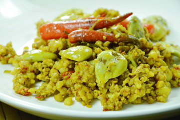 fried minced with flat bean in yellow curry on plate