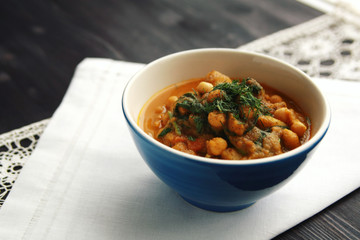 Simple vegetable soup. European cuisine. Chickpeas, potato and carrot. Organic food. Vegan dish. Vegetarian lunch.