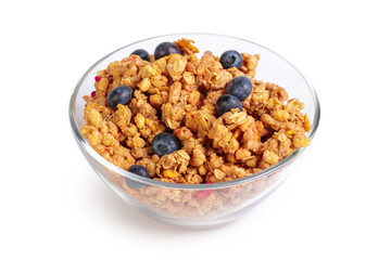 Bowl of homemade granola with fruit pieces isolated on white