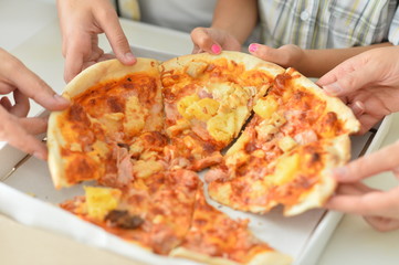 Happy family eating pizza together