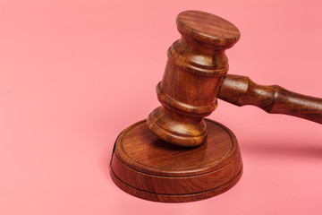 Judge gavel or auction on pink background. Justice and auction.