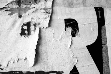 Black white old grunge ripped torn vintage collage posters creased crumpled paper surface texture background / Space for text