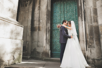 Gorgeous wedding couple walking in the old city of Lviv