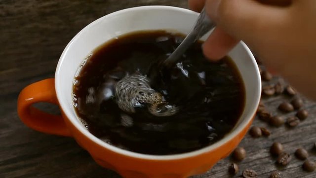 Coffee cup close up hd slow motion footage with coffee beans on the table