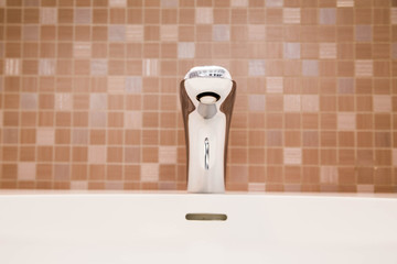 ceramic tiles, faucet and sink in the bathroom