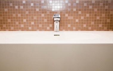 ceramic tiles, faucet and sink in the bathroom