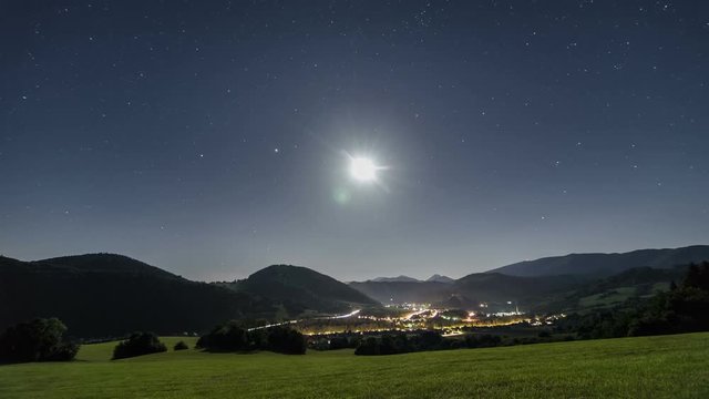 Starry night sky with moon light over rural country Time lapse