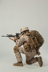 Soldier in camouflage holding rifle