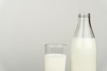 a glass of milk and milk bottle on white background