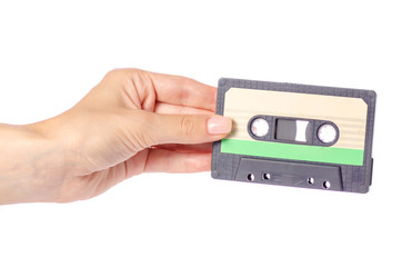 Fototapeta premium Audio cassette in hand stereo music on white background isolation