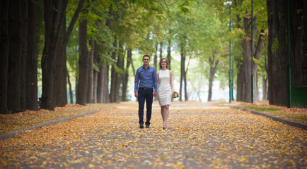 young man and woman on a walk in a park, happiness