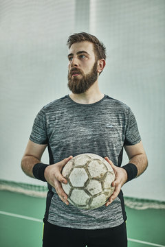 Portrait of indoor soccer player holding the ball