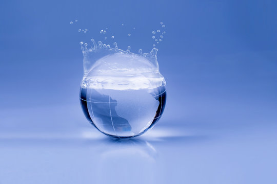 Water drops on the glass globe on blue background