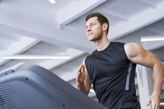 Man running on treadmill at gym