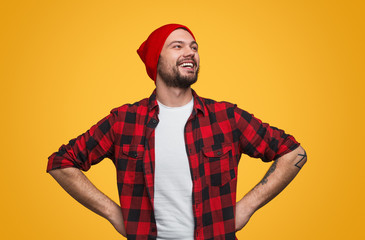 Proud laughing man with hands on waist