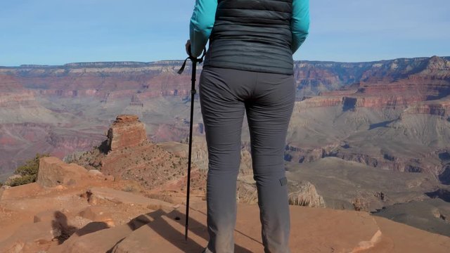 Female Tourist Enjoys The View Of The Grand Canyon From The Height