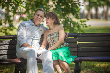 man and woman on a walk in the city park, family happiness