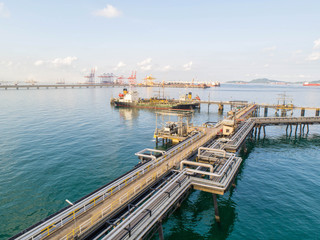 Naklejka premium oil tanker, gas tanker in the high sea.Refinery Industry cargo ship,aerial view,Thailand, in import export, LPG,oil refinery, Logistics and transportation with working crane bridge in harbor