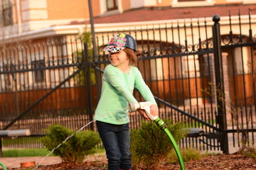 Girl watering a garden 