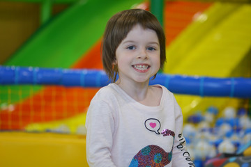 Fototapeta na wymiar Smiling girl at a playground