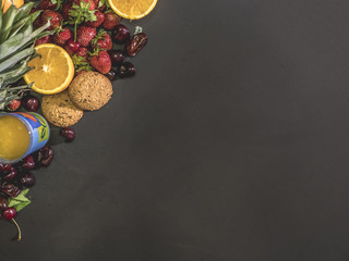 close up overhead biscuits with fresh fruits on black chalkboard copy space mockup
