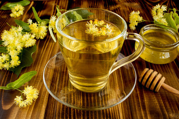 Tea with linden and honey  on the brown wooden background