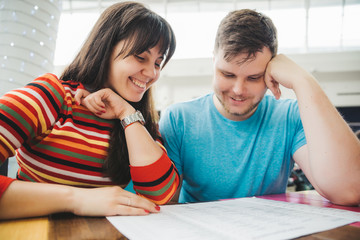 couple sitting in mall cafe. reading menu.