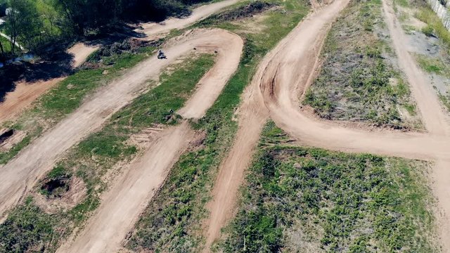 Professional motorcycler is racing across a motocross track.