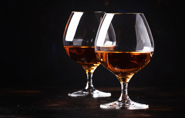 Cognac in a glass, dark background, selective focus