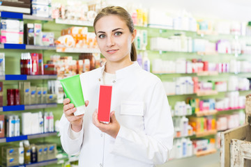 female pharmacist  is standing with medicine